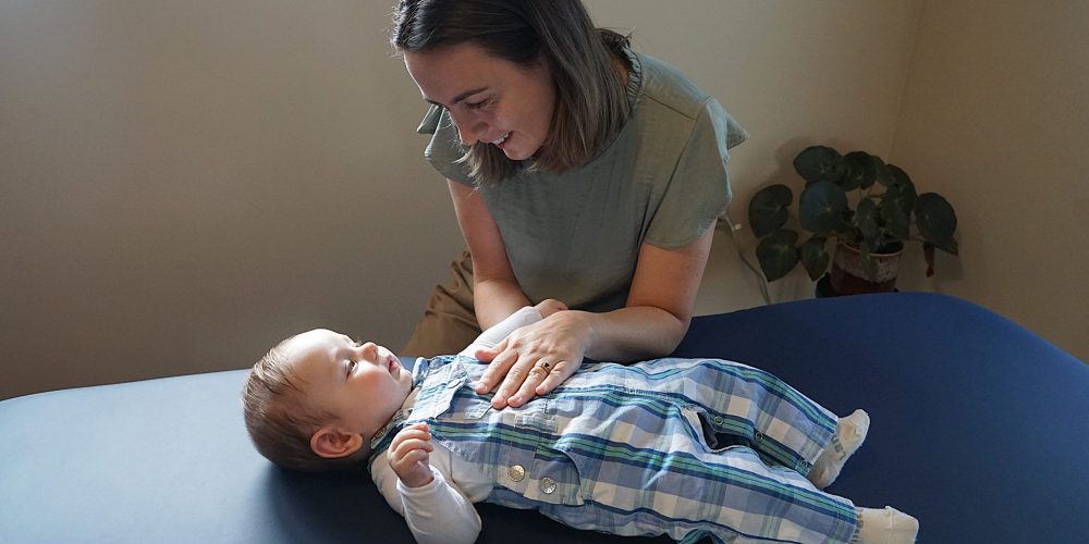 Osteopath in Christchurch performing gentle osteopathy treatment on a baby at Cashmere Osteo.
